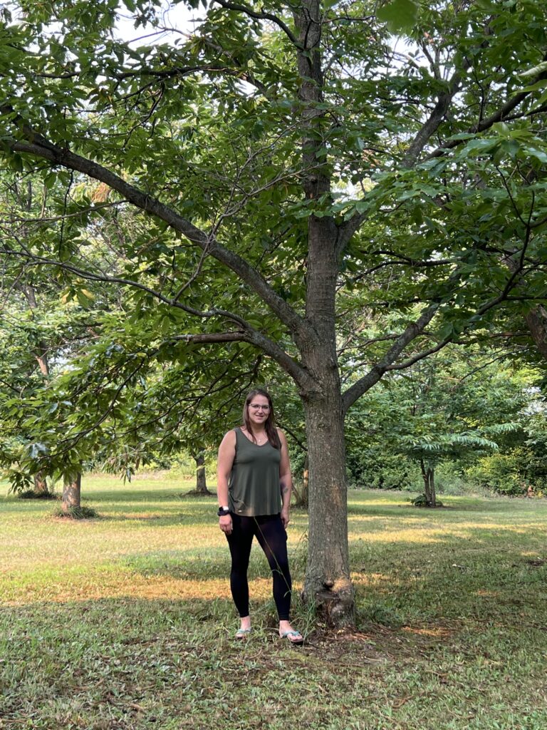 Amy Smith near her grandfather's favorite chestnut tree at Angle Acre Farm.