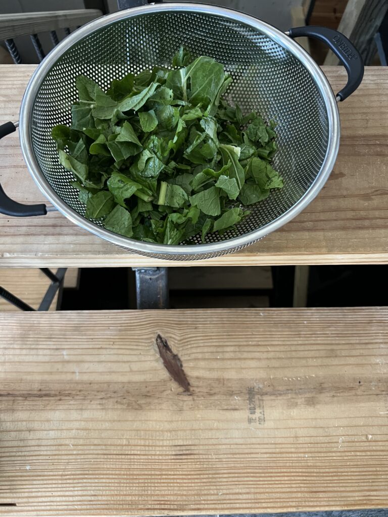 A bowl of greens used in a dish of country ribs with chestnuts